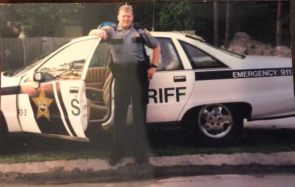 FASRO history - officer by car in vintage photo